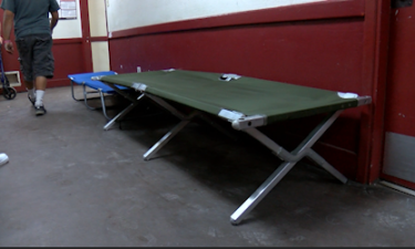 Crossroads Mission lays out cots in the hallway during overflow of guests.