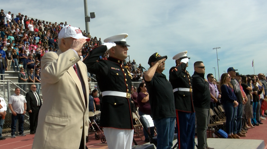 Veterans salute during the national anthem.