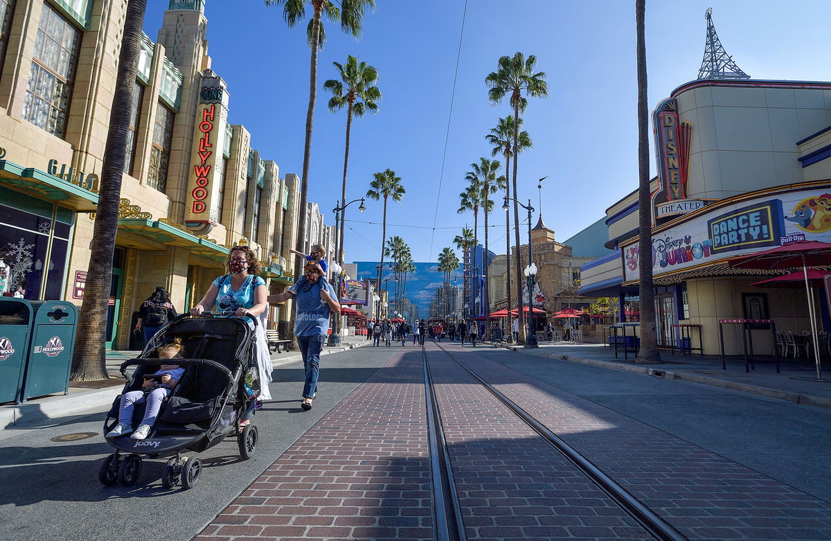 ANAHEIM, CA - NOVEMBER 19: Katie Crumley anther husband, Chris Crumley, walk Hollywood Blvd with their children Talulah, Flynn and Imogen inside Disney California Adventure Park in Anaheim, CA, on Thursday, November 19, 2020. The family drove from Denver to visit the park. The Disneyland Resort opened some retail and dining in the park as an extension of the Downtown Disney District. (Photo by Jeff Gritchen/MediaNews Group/Orange County Register via Getty Images)