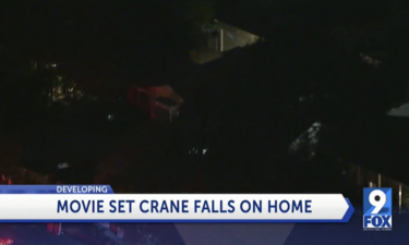 Crane falls on home