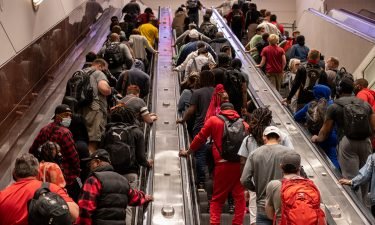 People ride up escalators on their way to baggage claim at Hartsfield-Jackson Atlanta International Airport in Atlanta