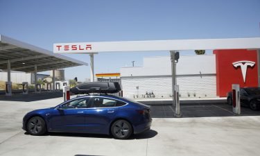 A Tesla Inc. Model 3 electric vehicles departs after charging at the Tesla Supercharger station in Kettleman City