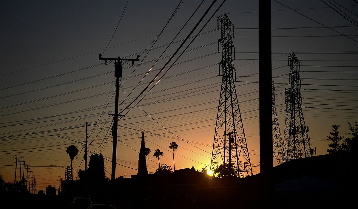 <i>Frederic J. Brown/AFP/Getty Images</i><br/>The sun sets behind power lines in Rosemead