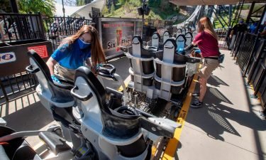 Employees sanitize roller coaster seats at Six Flags Magic Mountain in Valencia