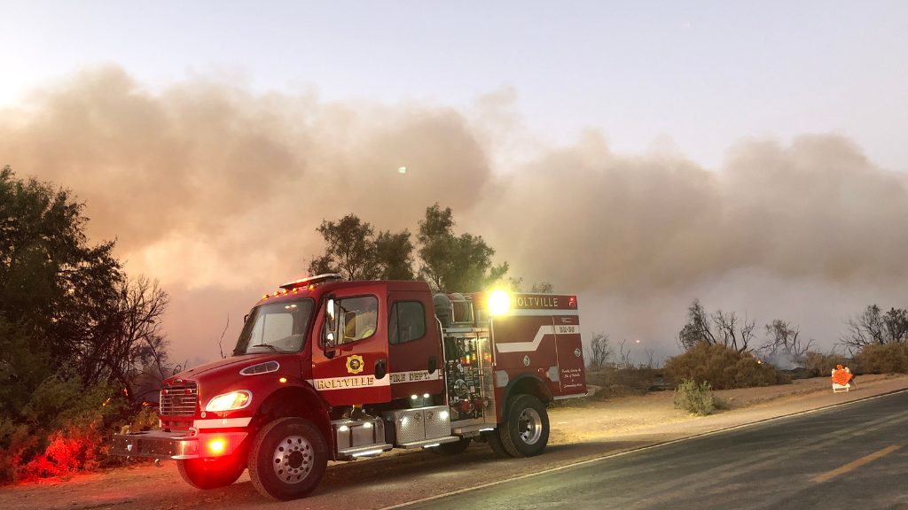 Fire crews battle a blaze burning along Rutherford Road near Wiest Lake