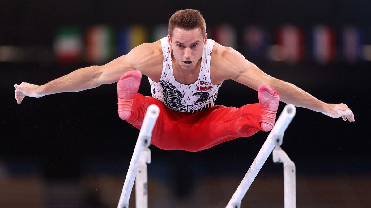 Sam Mikulak competes on parallel bars