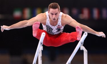 Sam Mikulak competes on parallel bars