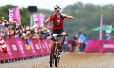 Linda Indergand of Team Switzerland crosses the finish line as he celebrates winning a bronze medal during the Women's Cross-country race on day four of the Tokyo 2020 Olympic Games