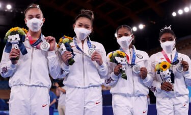 women's gymnastics team shows off silver medals