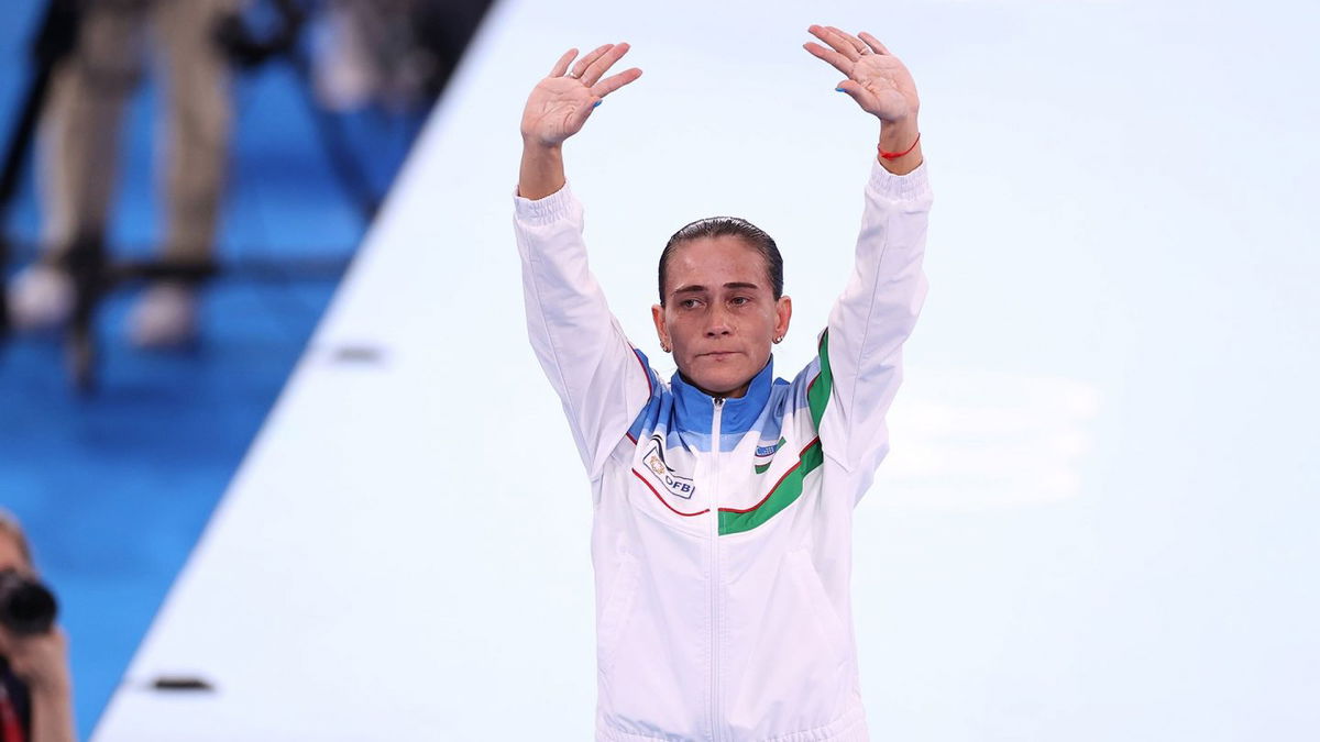 Eight-time Olympian Oksana Chusovitina waves after competing on vault at the Tokyo Olympics