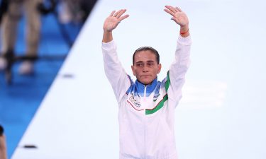 Eight-time Olympian Oksana Chusovitina waves after competing on vault at the Tokyo Olympics