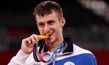 Gold medalist Vladislav Larin of Team ROC poses with the gold medal for the Men's +80kg Taekwondo on day four of the Tokyo 2020 Olympic Games