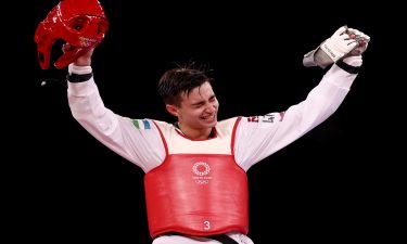 Ulugbek Rashitov celebrates winning a gold medal in taekwondo