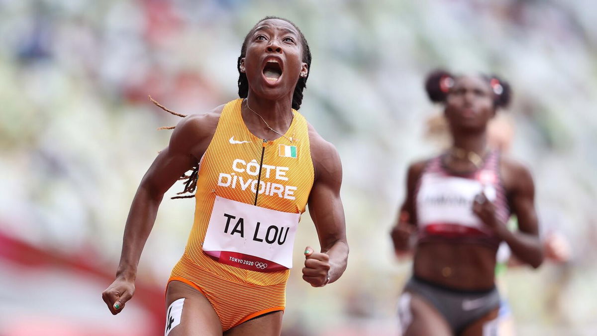 Marie-Josee Ta Lou of Team Ivory Coast reacts while competing during round one of the Women's 100m heats