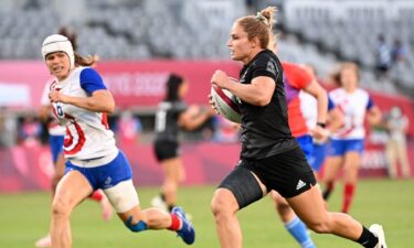 New Zealand's Michaela Blyde runs past France's Camille Grassineau to score a try in the women's rugby sevens final