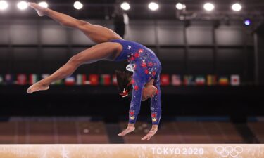 Simone Biles performs a back-handspring on balance beam during the qualification round of the women's artistic gymnastics competition in Tokyo.