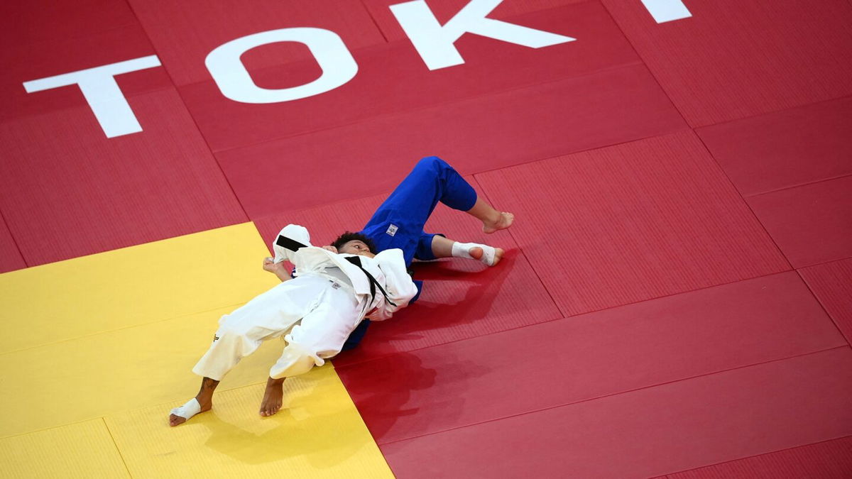 France's Amandine Buchard (white) competes with Switzerland's Fabienne Kocher during their judo women's -52kg semifinal A bout during the Tokyo 2020 Olympic Games at the Nippon Budokan in Tokyo on July 25