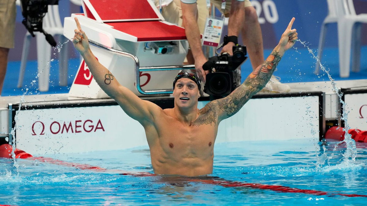 Caeleb Dressel celebrates in the water