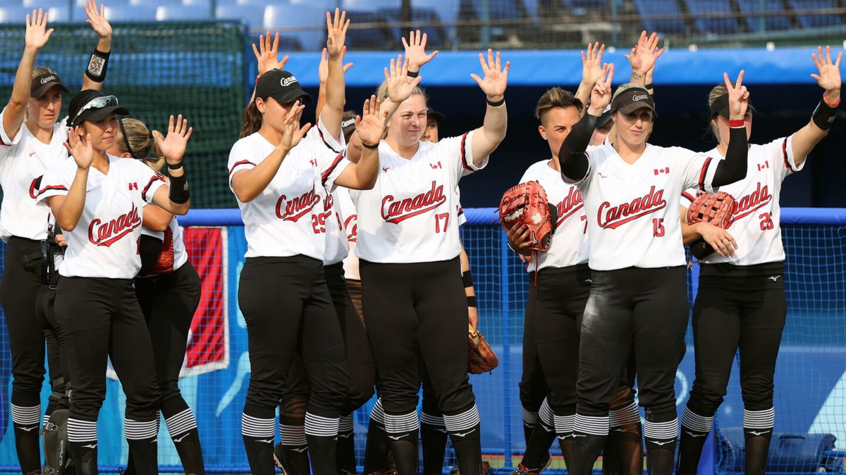 Team Canada wave to Team Italy after their game during softball opening round on day three of the Tokyo 2020 Olympic Games