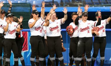 Team Canada wave to Team Italy after their game during softball opening round on day three of the Tokyo 2020 Olympic Games