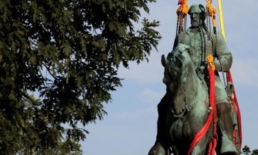 Workers remove a statue of Confederate Gen. Robert E. Lee from Market Street Park on Saturday in Charlottesville