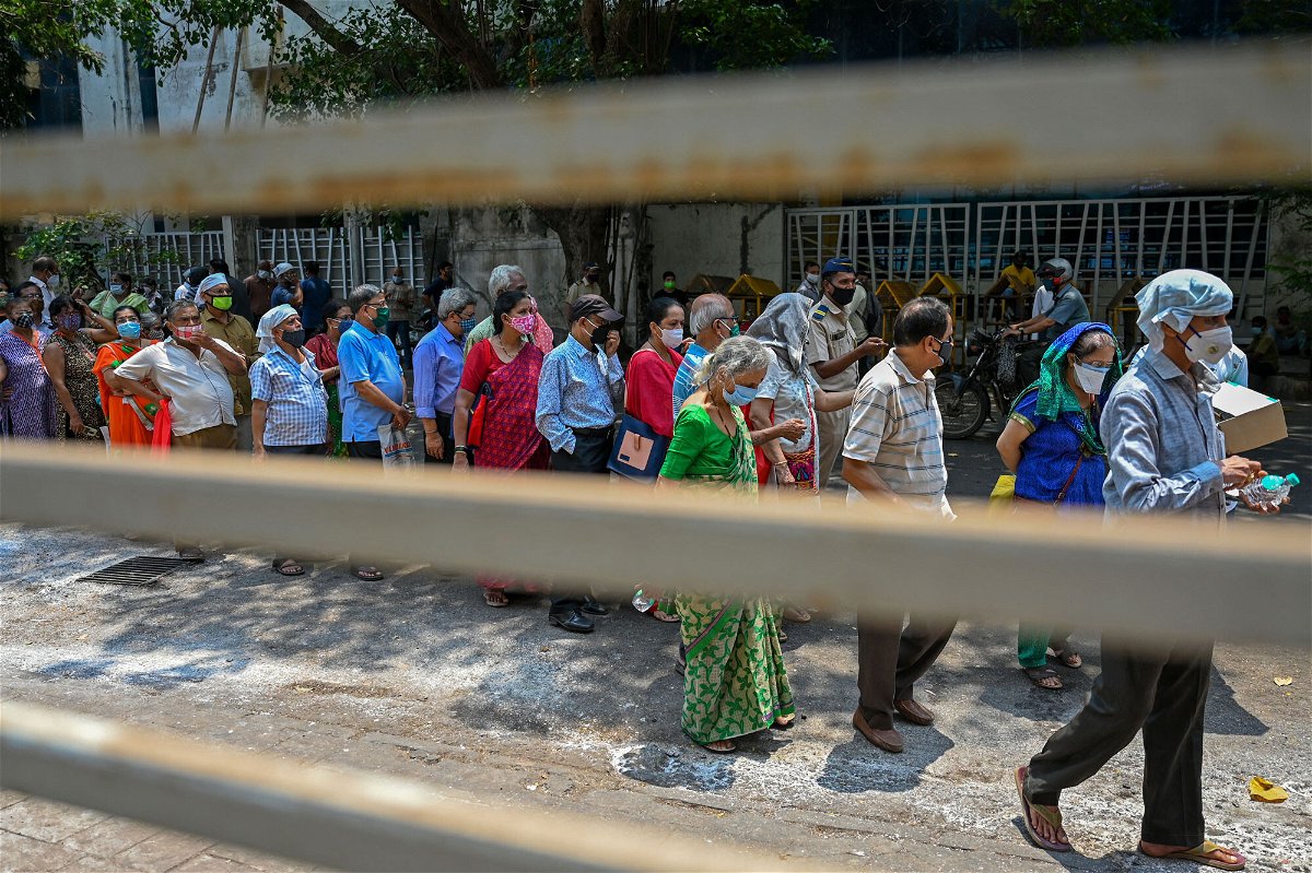 <i>Punit Paranjpe/AFP/Getty Images</i><br/>People line up to receive coronavirus vaccine shots in Mumbai