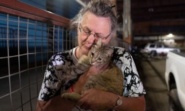Dee McCarley hugs her cat Bunny
