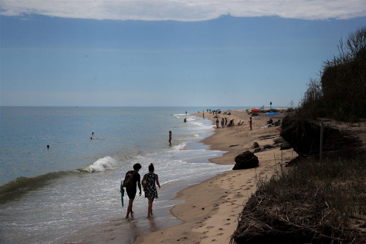 <i>Craig F. Walker/The Boston Globe/Getty Images</i><br/>A couple walks the shore at Coast Guard Beach in Eastham on Cape Cod.