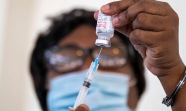 A health worker prepares a dose of the Moderna Covid-19 vaccine at the Saint Damien Hospital in Port-au-Prince