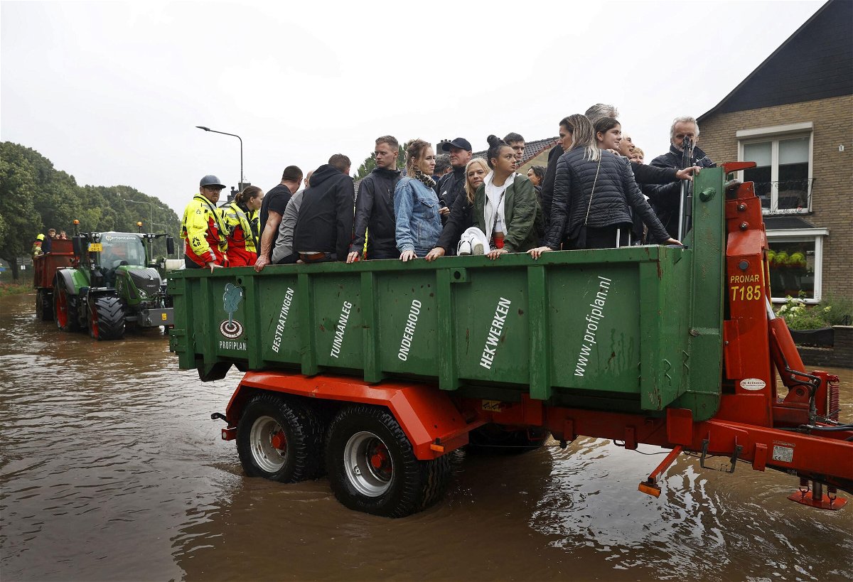 <i>Sem van der Wal/ANP/AFP/Getty Images</i><br/>People ride on a trailer as the Dutch fire brigade evacuate people from their homes in South Limburg.