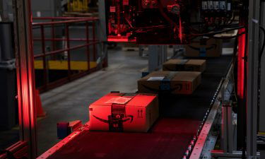A package pass a scanner while moving along a conveyor at an Amazon.com Inc. fulfillment center in New Jersey