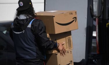 An Amazon.com Inc. delivery driver carries boxes into a van outside of a distribution facility on February 2 in Hawthorne