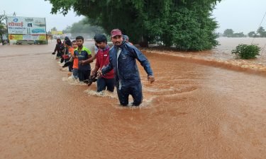 National Disaster Response Force personnel rescue people stranded in floodwaters in Kolhapur