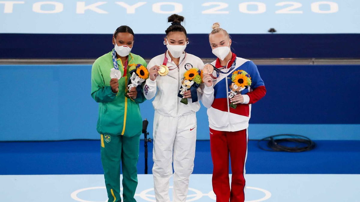 Suni Lee watches back all-around medal ceremony