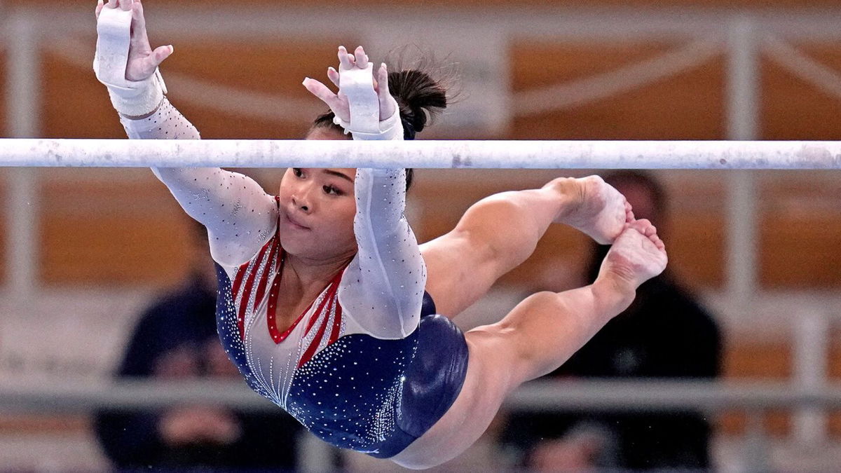 Suni Lee competes on the uneven bars