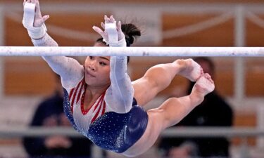 Suni Lee competes on the uneven bars