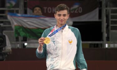 Uzbekistan's Ulugbek Rashitov receives taekwondo gold medal