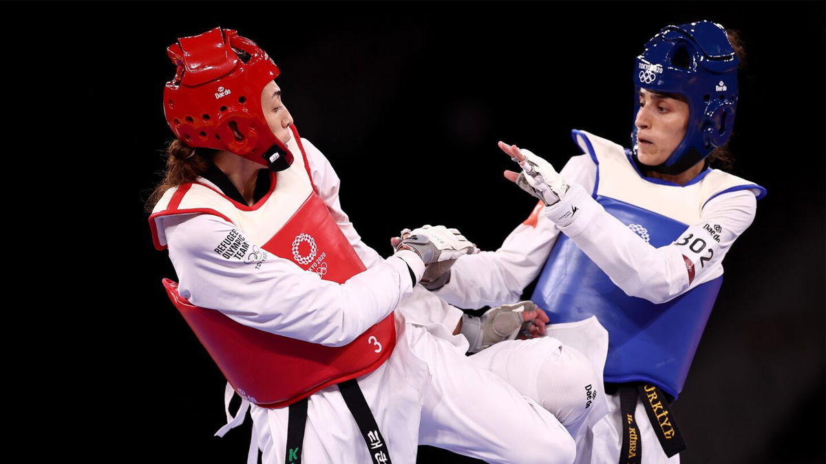 Lo Chia-Ling and Tekiath Ben Yessouf kick towards each other mid-competition