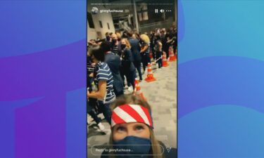 A U.S. athlete poses for a selfie in front of a crowd before the Opening Ceremony