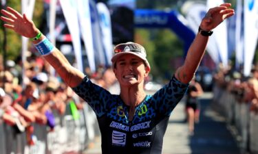 Rach McBride of Canada celebrates a third place finish in the Pro Women's Division during the Subaru Ironman Canada triathlon on July 30