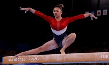 Sunisa Lee competes on the balance beam during the team final of the women's artistic gymnastics competition in Tokyo