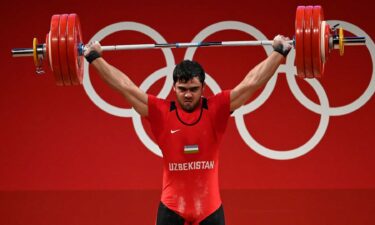 Akbar Djuraev of Uzbekistan competes in the men's 109 kg weightlifting competition at the 2020 Tokyo Olympic Games.