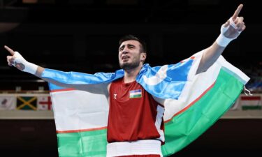 Bakhodir Jalolov of Uzbekistan celebrates his gold medal boxing win in the super heavyweight category at the 2020 Tokyo Olympic Games