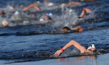 Germany's Florian Wellbrock competes to win and take gold in the men's 10km marathon swimming event during the Tokyo 2020 Olympic Games.