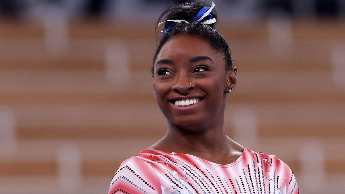 Simone Biles smiles after beam routine