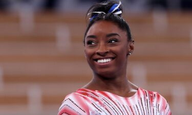 Simone Biles smiles after beam routine