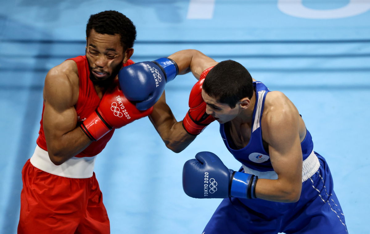 Duke Ragan (red) of Team United States exchanges punches with Albert Batyrgaziev of Team Russian Olympic Committee.