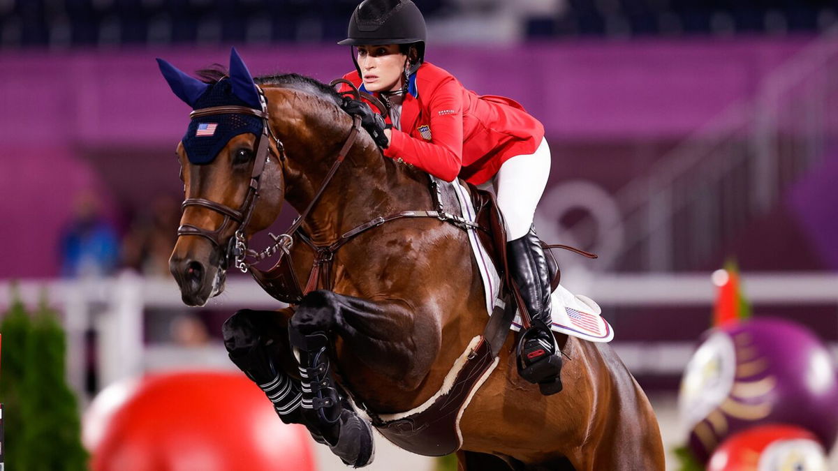 Jessica Springsteen and her horse in the air mid jump