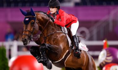 Jessica Springsteen and her horse in the air mid jump