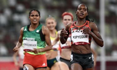 Kenya's Faith Kipyegon (R) wins ahead of Ethiopia's Freweyni Gebreezibeher (L) in the women's 1500m semi-finals during the Tokyo 2020 Olympic Games